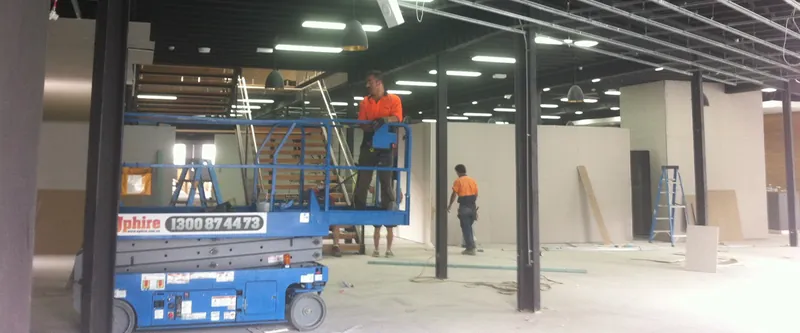 Camperdown fit-out: scissor lift and tradespeople working on ceilings