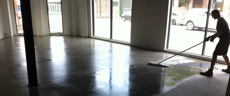 Camperdown fit-out: concrete floor being cleaned in the finished space