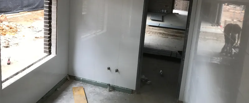 College building: room with new walls and window ready for finishing