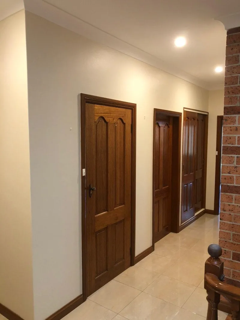 Hallway with timber doors, cornices and tiled floor