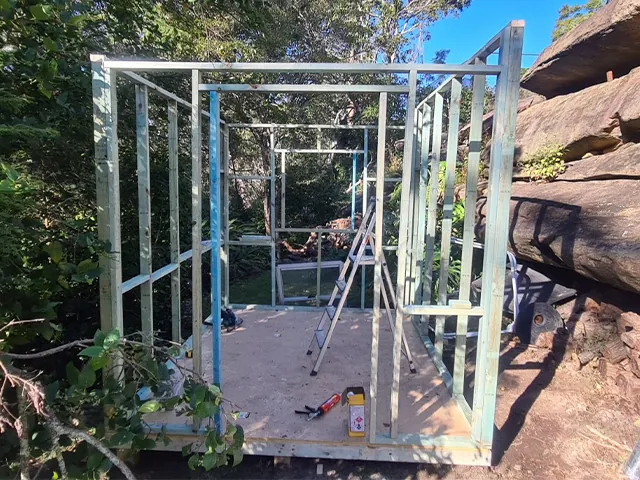 Lindfield: steel-framed structure under construction on a bush block
