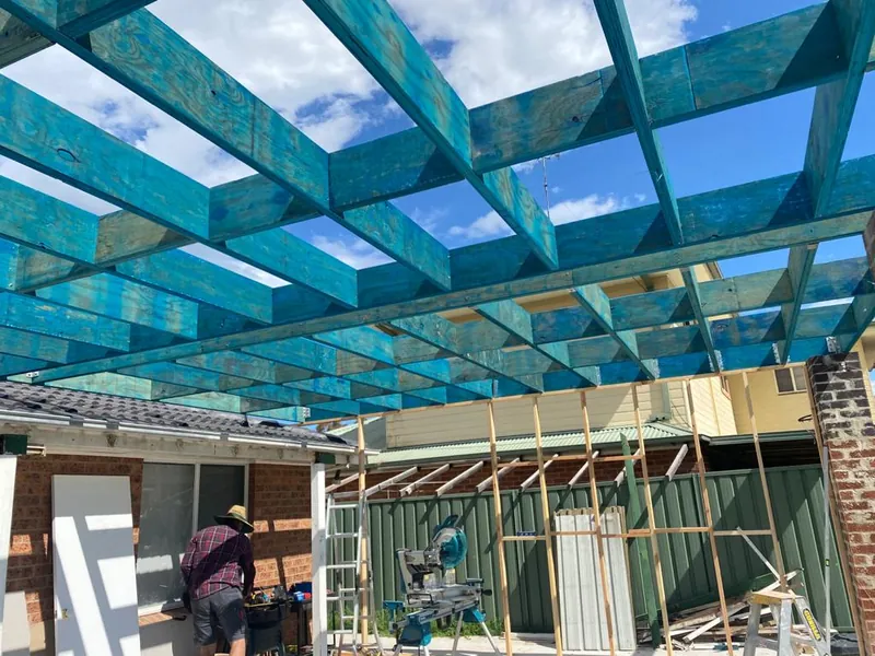 Pergola rafters going up over the deck frame