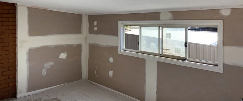 Room with new plasterboard walls set and ready for painting